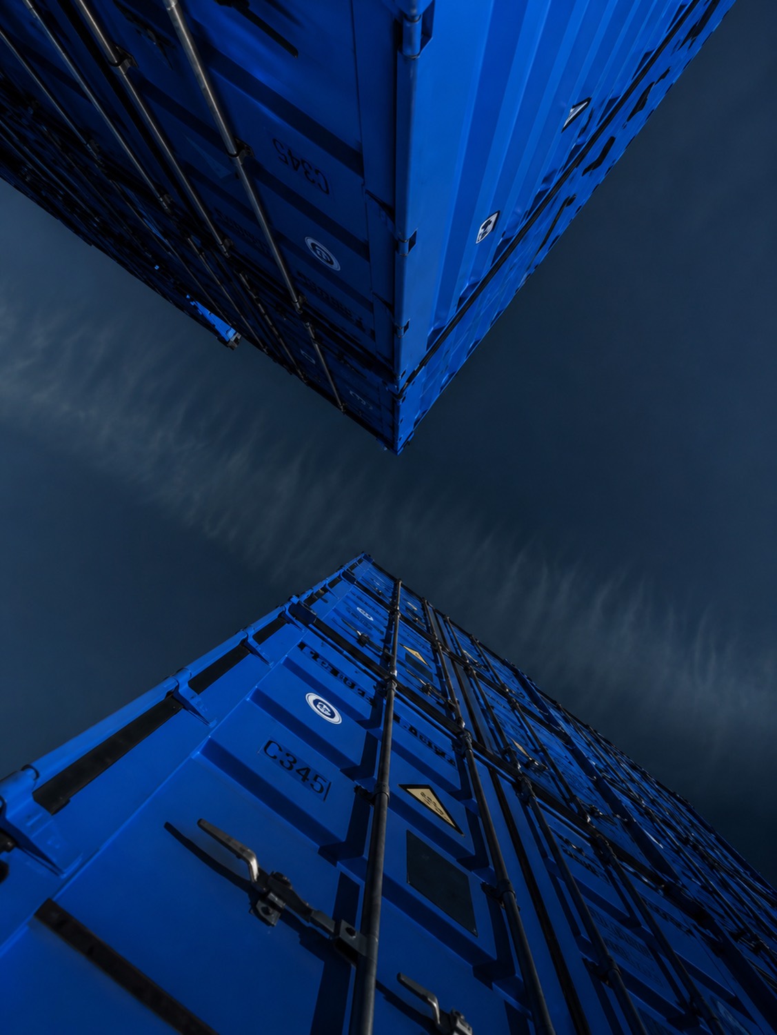 Stacked shipping containers in storage at a logistics yard